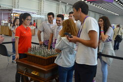 Hou Yifan, the world chess champion, and visitors of the exhibition played a game on the unique chess set "Marches on Bosporan".